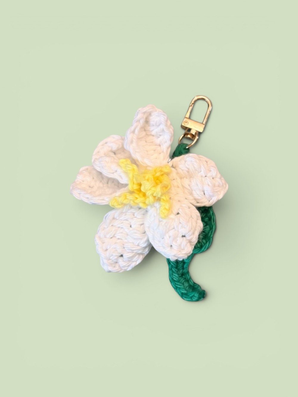 Crocheted White Flower Keychain with Green Leaf and Yellow Center